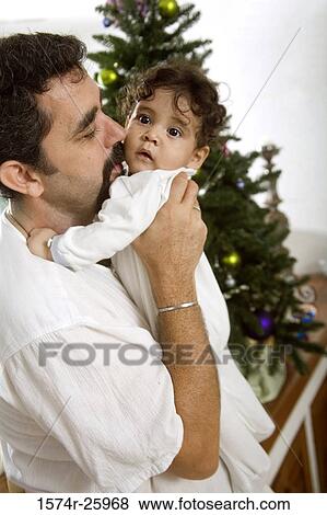 Mature man holding his baby View Large Photo Image Stock Photo - Mature man holding his baby. Fotosearch