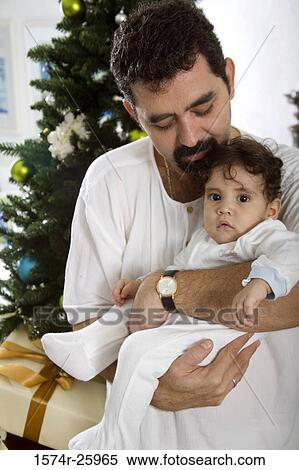 Stock Photography - Mature man holding his baby. Fotosearch