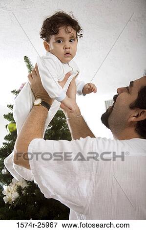 Mature man lifting his baby View Large Photo Image Stock Photo - Mature man lifting his baby. Fotosearch