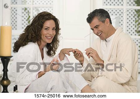 Mature man painting the fingernails of a mid adult woman View Large Photo Image Stock Photograph - Mature man painting the fingernails of a mid adult woman. Fotosearch