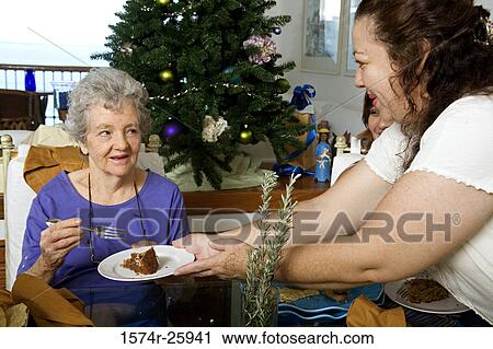 Mature woman giving a cake to a senior woman View Large Photo Image Stock Image - Mature woman giving a cake to a senior woman. Fotosearch