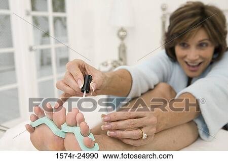 Mature woman painting her toenails View Large Photo Image Stock Image - Mature woman painting her toenails. Fotosearch