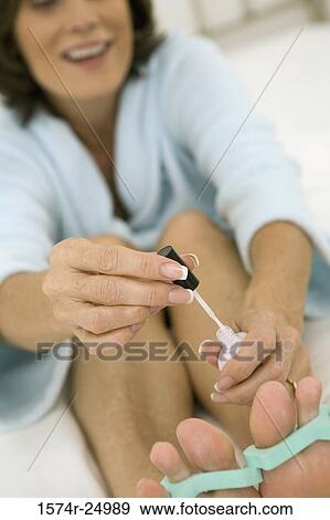 Mature woman painting her toenails View Large Photo Image Stock Photo - Mature woman painting her toenails. Fotosearch