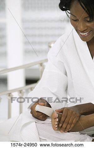 Mature woman scrubbing her foot with a pumice stone View Large Photo Image Stock Image - Mature woman scrubbing her foot with a pumice stone. Fotosearch
