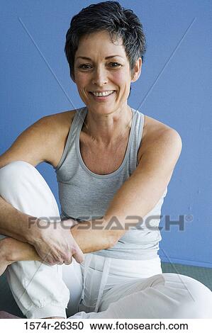 Mature woman sitting and smiling View Large Photo Image Stock Image - Mature woman sitting and smiling. Fotosearch
