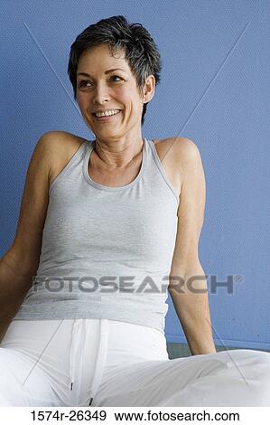 Mature woman sitting and smiling View Large Photo Image Stock Photo - Mature woman sitting and smiling. Fotosearch