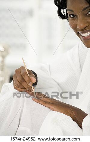 Mature woman touching her fingernail with a cuticle stick View Large Photo Image Stock Image - Mature woman touching her fingernail with a cuticle stick. Fotosearch