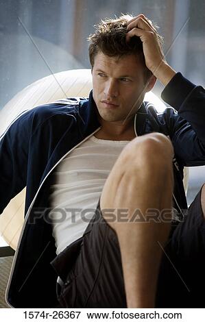 Mid adult man leaning against a fitness ball View Large Photo Image Stock Photo - Mid adult man leaning against a fitness ball. Fotosearch
