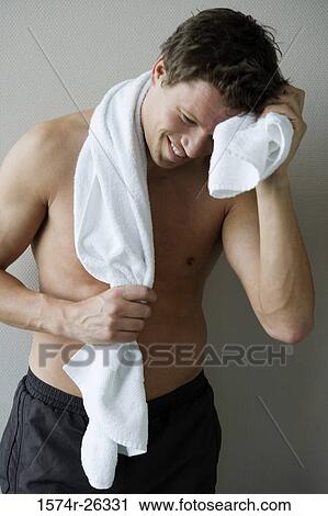 Mid adult man wiping sweat from his forehead View Large Photo Image Stock Image - Mid adult man wiping sweat from his forehead. Fotosearch