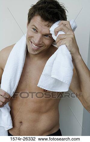 Mid adult man wiping sweat from his forehead View Large Photo Image Stock Image - Mid adult man wiping sweat from his forehead. Fotosearch