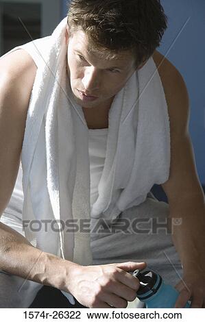 Mid adult man with a towel around his neck View Large Photo Image Stock Image - Mid adult man with a towel around his neck. Fotosearch