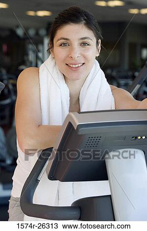 Stock Image - Mid adult woman exercising. Fotosearch