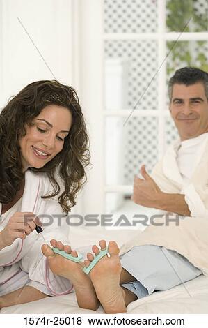Mid adult woman painting the toenails of a mature man View Large Photo Image Stock Photo - Mid adult woman painting the toenails of a mature man. Fotosearch