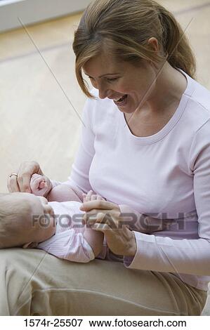 Mid adult woman playing with her daughter View Large Photo Image Stock Photo - Mid adult woman playing with her daughter. Fotosearch