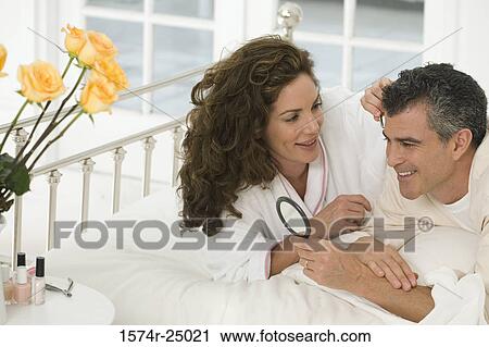 Mid adult woman plucking the eyebrows of a mature man View Large Photo Image Stock Image - Mid adult woman plucking the eyebrows of a mature man. Fotosearch