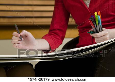Mid section view of a businesswoman drawing on a sketch pad View Large Photo Image Stock Photo - Mid section view of a businesswoman drawing on a sketch pad. Fotosearch