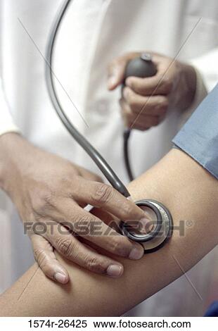 Mid section view of a doctor checking the blood pressure of a patient View Large Photo Image Stock Photography - Mid section view of a doctor checking the blood pressure of a patient. Fotosearch