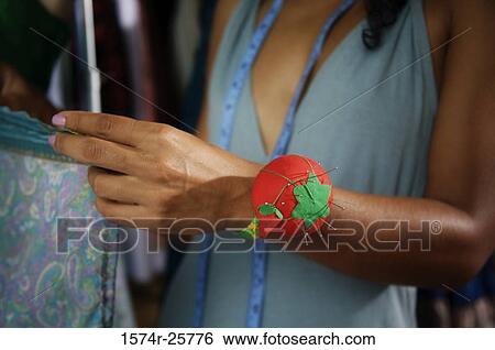 Mid section view of a female fashion designer working on a dress in a clothing store View Large Photo Image Stock Photograph - Mid section view of a female fashion designer working on a dress in a clothing store. Fotosearch