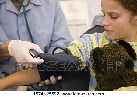Mid section view of a male doctor checking the blood pressure of a patient View Large Photo Image Stock Image - Mid section view of a male doctor checking the blood pressure of a patient. Fotosearch
