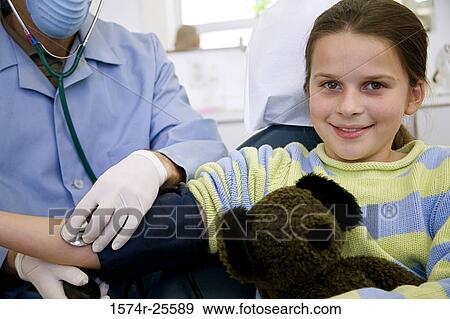 Mid section view of a male doctor checking the blood pressure of a patient View Large Photo Image Stock Photo - Mid section view of a male doctor checking the blood pressure of a patient. Fotosearch