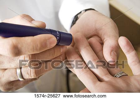 Mid section view of a male doctor taking a blood sample from a patient's finger View Large Photo Image Stock Photo - Mid section view of a male doctor taking a blood sample from a patient's finger. Fotosearch