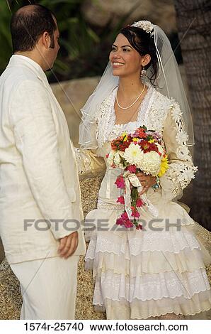 Newlywed couple looking at each other View Large Photo Image Stock Image - Newlywed couple looking at each other. Fotosearch