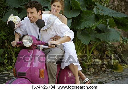 Newlywed couple riding a motor scooter View Large Photo Image Picture - Newlywed couple riding a motor scooter. Fotosearch