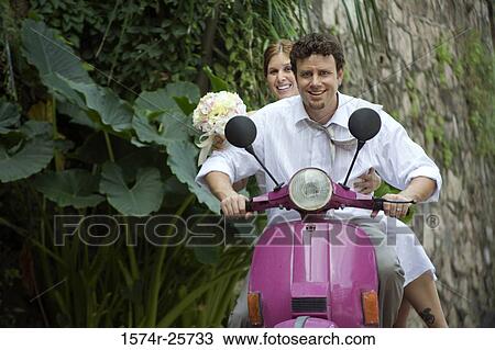 Newlywed couple riding a motor scooter View Large Photo Image Stock Image - Newlywed couple riding a motor scooter. Fotosearch