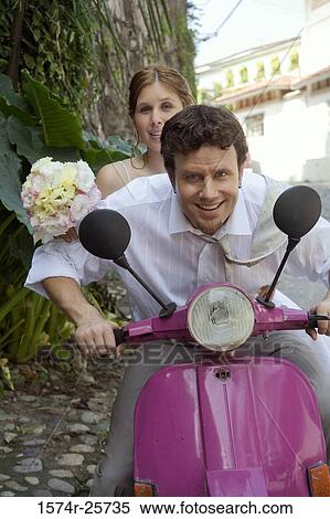 Newlywed couple sitting on a motor scooter View Large Photo Image Stock Photography - Newlywed couple sitting on a motor scooter. Fotosearch