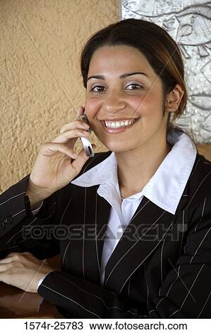 Stock Image - Portrait of a businesswoman talking on a mobile phone. Fotosearch