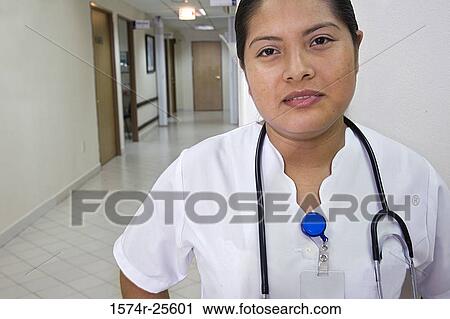 Stock Image - Portrait of a female nurse with a stethoscope around her neck. Fotosearch