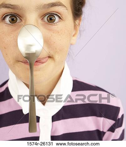 Portrait of a girl balancing a spoon on her nose View Large Photo Image Stock Image - Portrait of a girl balancing a spoon on her nose. Fotosearch