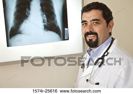 Portrait of a male doctor smiling in front of an x-ray image View Large Photo Image Stock Photograph - Portrait of a male doctor smiling in front of an x-ray image. Fotosearch