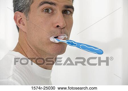 Portrait of a mature man brushing his teeth View Large Photo Image Stock Image - Portrait of a mature man brushing his teeth. Fotosearch