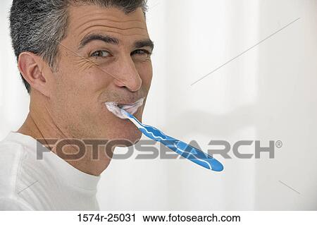 Portrait of a mature man brushing his teeth View Large Photo Image Stock Image - Portrait of a mature man brushing his teeth. Fotosearch