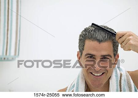 Portrait of a mature man combing his hair View Large Photo Image Stock Photography - Portrait of a mature man combing his hair. Fotosearch
