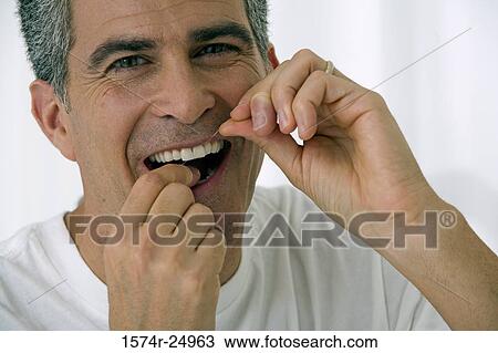 Portrait of a mature man flossing his teeth View Large Photo Image Stock Image - Portrait of a mature man flossing his teeth. Fotosearch