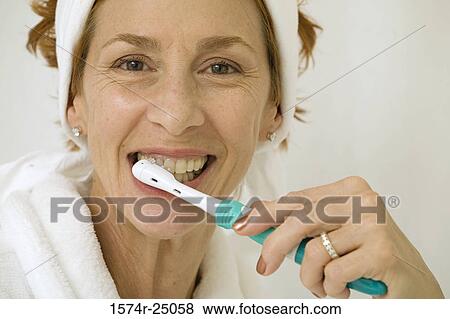 Portrait of a mature woman brushing her teeth View Large Photo Image Stock Photo - Portrait of a mature woman brushing her teeth. Fotosearch