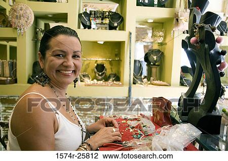 Portrait of a mature woman making jewelry in a souvenir store View Large Photo Image Stock Image - Portrait of a mature woman making jewelry in a souvenir store. Fotosearch