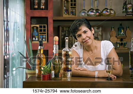 Picture - Portrait of a mature woman standing in a cafe. Fotosearch