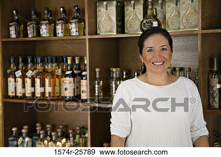 Portrait of a mature woman standing in a cafe View Large Photo Image Stock Photo - Portrait of a mature woman standing in a cafe. Fotosearch