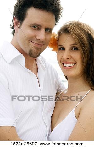 Portrait of a mid adult man embracing a young woman View Large Photo Image Stock Photo - Portrait of a mid adult man embracing a young woman. Fotosearch