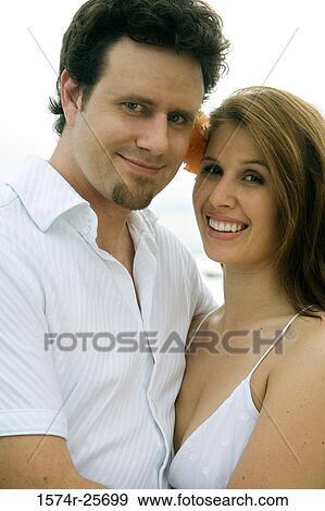 Portrait of a mid adult man embracing a young woman View Large Photo Image Stock Photo - Portrait of a mid adult man embracing a young woman. Fotosearch