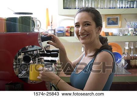 Portrait of a mid adult woman operating a coffee maker in a cafe View Large Photo Image Stock Image - Portrait of a mid adult woman operating a coffee maker in a cafe. Fotosearch