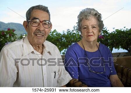 Portrait of a senior man with a senior woman sitting and smiling View Large Photo Image Stock Image - Portrait of a senior man with a senior woman sitting and smiling. Fotosearch