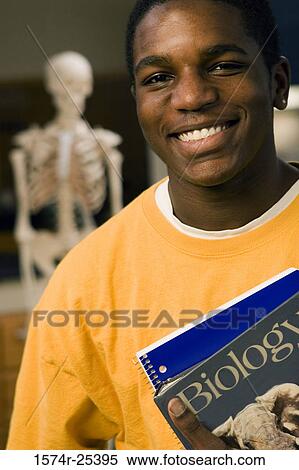 Portrait of a student holding books View Large Photo Image Stock Photography - Portrait of a student holding books. Fotosearch