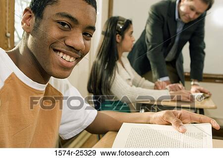 Stock Photo - Portrait of a student smiling in a classroom. Fotosearch