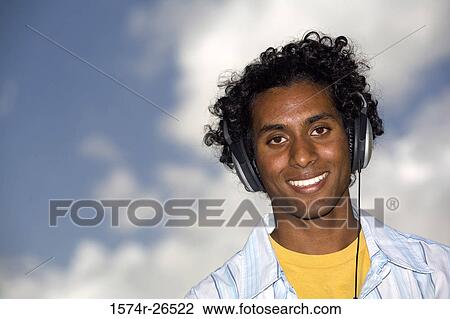 Portrait of a young man wearing headphones View Large Photo Image Stock Image - Portrait of a young man wearing headphones. Fotosearch