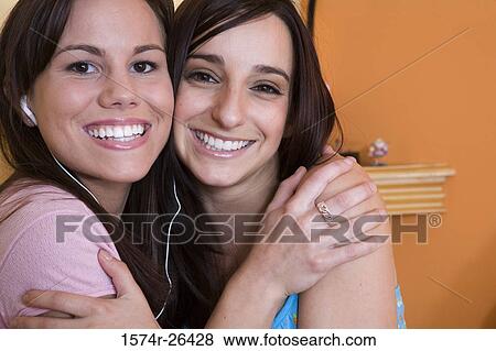 Portrait of a young woman and a teenage girl hugging View Large Photo Image Stock Photo - Portrait of a young woman and a teenage girl hugging. Fotosearch
