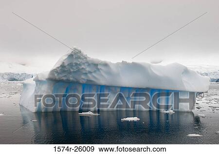 Stock Photo - Reflection of an iceberg in water. Fotosearch